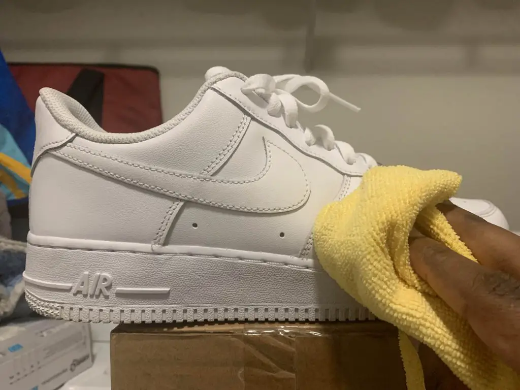 Cleaning white air force one sneaker with a microfiber cloth