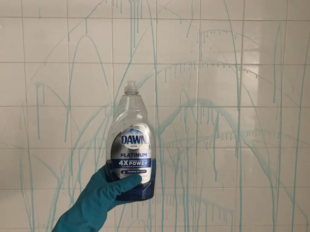 dawn dish soap being used to clean shower tiles