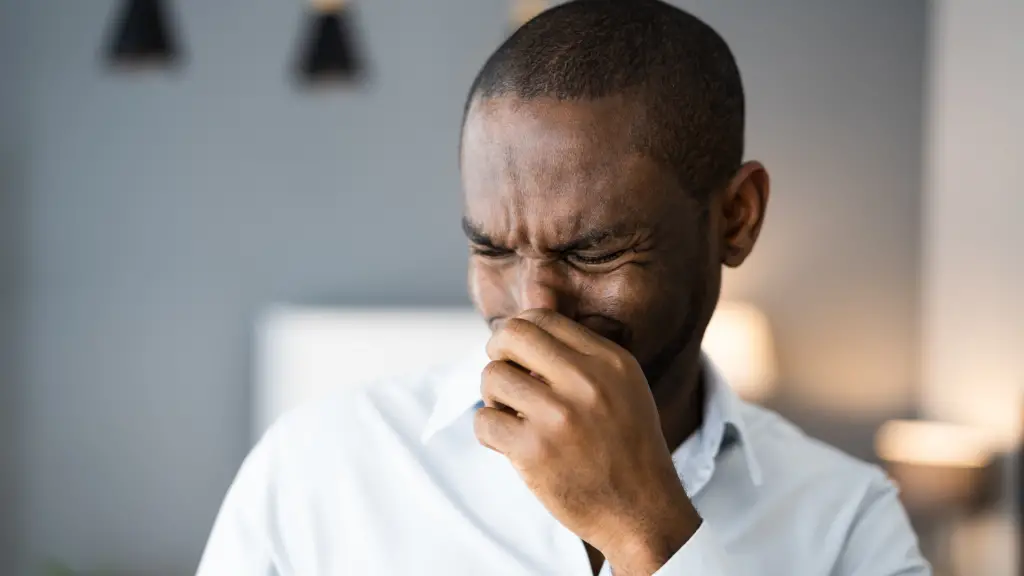 man covering his nose because of a bad smell