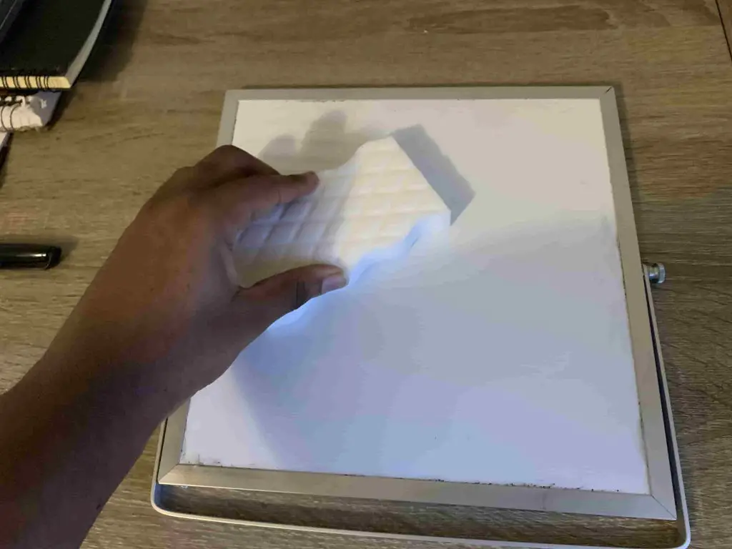 cleaning a whiteboard using a magic eraser sponge