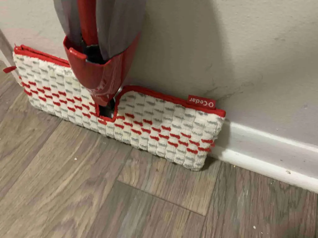 cleaning baseboard using a mop