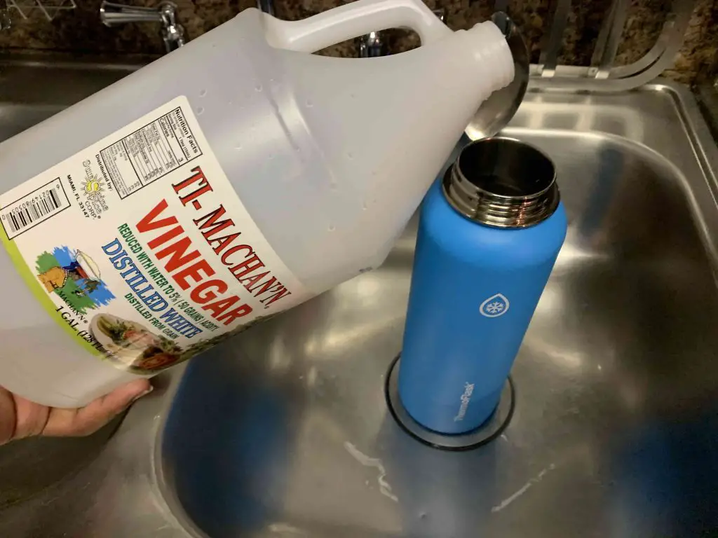 pouring vinegar inside of thermoflask