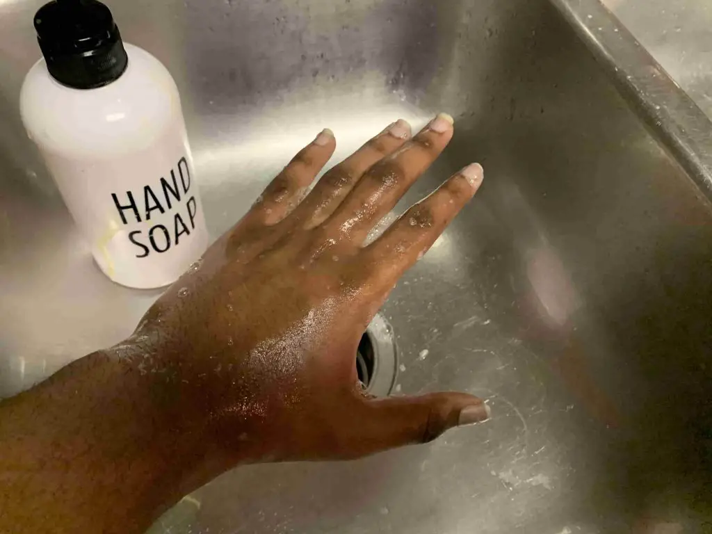 using hand soap to wash hand