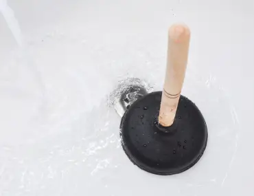 plunger being cleaned