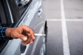had holding a cigarette inside a car
