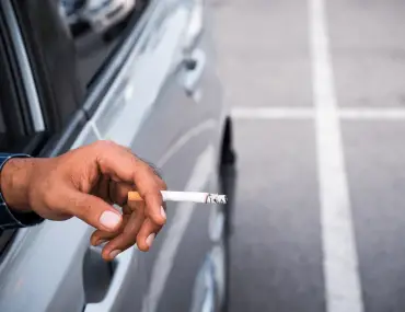 had holding a cigarette inside a car